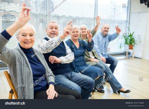 stock-photo-senior-citizens-participating-in-group-event-in-retirement-home-2437733965